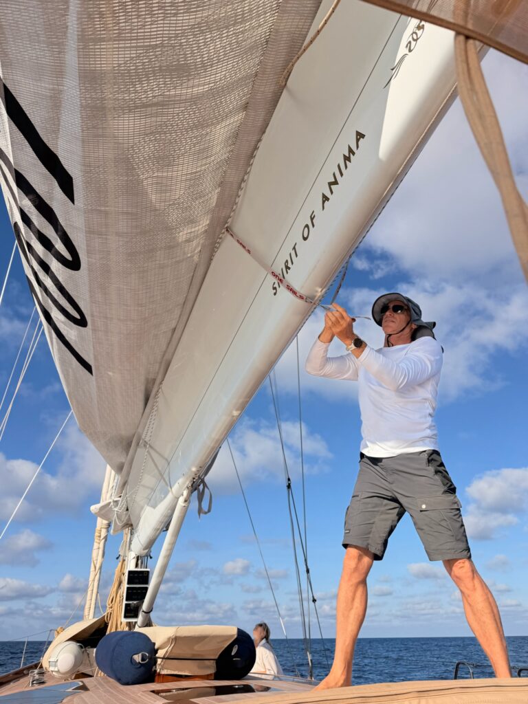 Captain Tomer Lanis handling the sails on deck of Anima II